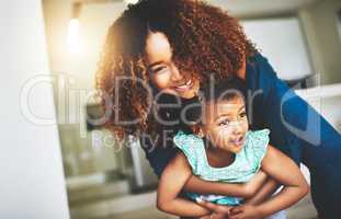 Motherhood is knowing joy. a young mother and her daughter spending quality time together at home.