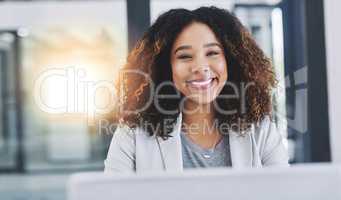 I always put full effort into every task. Portrait of a young businesswoman working on a laptop in an office.