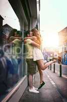 Romance can strike anywhere, anytime. an affectionate young couple hugging while exploring a foreign city.