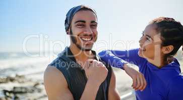 The sun is out lets have fun. Portrait of two young cheerful friends hanging out together before a fitness exercise outside during the day.