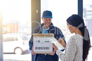 Your signature is all I need. a handsome delivery man getting a signature from a female customer for her order.