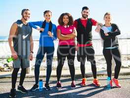 Did someone call us. Portrait of a cheerful young group of friends standing together before a fitness exercise outside during the day.