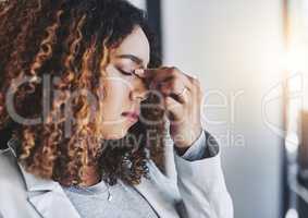 Stress can put your physical and mental health at risk. a young businesswoman looking stressed out in an office.