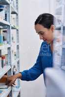 So much to choose from. a young woman shopping at a pharmacy.