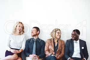Sharing our success stories. a group of entrepreneurs sitting against a white background.