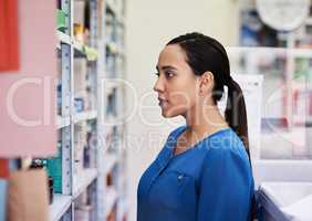 I have to make sure I choose the correct meds. a young woman shopping at a pharmacy.