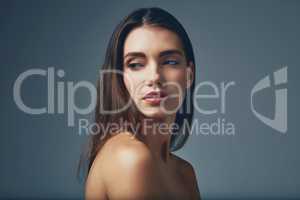 So simple, yet so stunning. Studio shot of a beautiful young woman posing against a blue background.