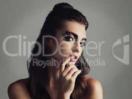 Makeup allows you to be anything you want. Studio shot of an attractive young woman wearing bold eye makeup.