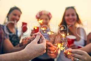 Putting some sparkle into the day. young people hanging out at the beach.