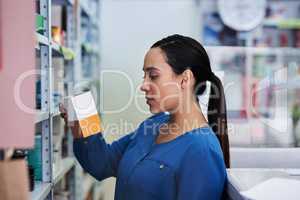 This looks like the correct meds. a young woman shopping at a pharmacy.