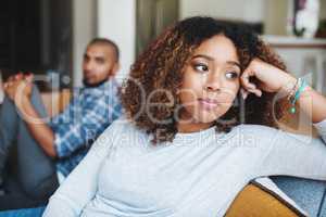 How will we get past this. an attractive young woman looking upset after an argument with her husband in their home.