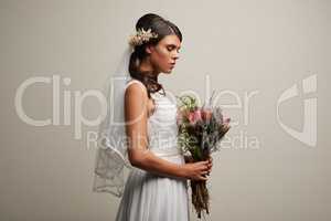 Classically beautiful. Studio shot of a young beautiful bride posing against a grey background.