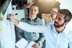 Making calculated decisions on their next move. a group of businesspeople brainstorming in an office.