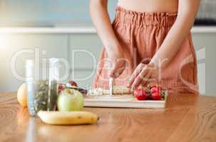Woman making healthy smoothie for energy, nutrition and wellness with fresh organic fruit being cut, sliced and prepared. Delicious detox drink, wholesome diet and cleanse with vitamins and nutrients