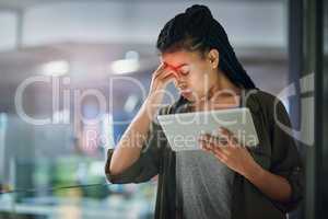 This headache isnt helping my productivity. a young businesswoman experiencing a headache at the office.