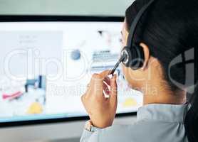Call center agent giving online support with computer screen, working as advisor and doing telemarketing in an office at work from behind. Closeup of customer service representative talking with pc