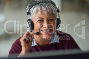 Helpful advice is just a call away. Portrait of a mature woman working in a call centre.