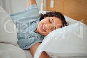 Carefree, rested while stretching in in bed in the morning. Relaxing and enjoying free time while sleeping in. Cozy, smiling and waking up with a positive mindset while lying in bed after good sleep