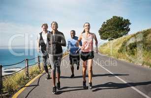 We know the benefits of regular exercise. a group of people out running together.
