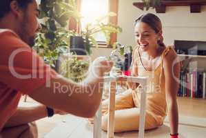 DIY, home improvement and fun couple painting a table or doing chores together at home and enjoying housework. Joyful, excited and cheerful lovers laughing and decorating their house