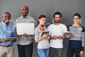 Success is easy with the right tools. Studio shot of businesspeople using wireless technology against a gray background.