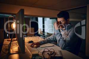 Wish these deadlines would just disappear. a young businessman looking stressed out while working in an office.