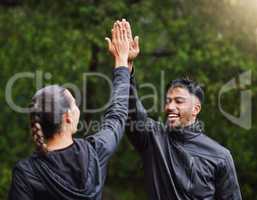 Active, fit and sporty athletes doing a high five to celebrate and congratulate on fitness goals. Healthy, happy and exercising couple motivated after training, getting cardio workout outside