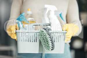 Closeup of house cleaning supplies, floor scrubbing and washing tools or products in an organized basket. Cleaner, housekeeper or maid with spray bottles and hygiene equipment for work or chores