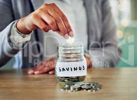 . Savings jar, money coins and change of a woman hand holding and saving cash to budget. A female planning investment, retirement and financial security. Closeup of financial growth for the future.