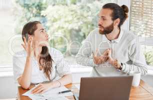 Stress, finance and arguing couple talking about budget, home loan and bills while sitting with tax papers and laptop . Man and woman with problem upset about bad financial debt and mortgage payment