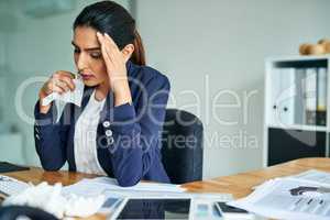 I cant be productive when Im feeling like this. a young businesswoman suffering with allergies at work.