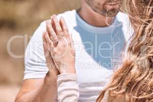 Closeup of an engaged couple holding hands showing their romance, love and care. Caucasian man and woman after a sweet, romantic and special proposal. Lady showing off her beautiful engagement ring.