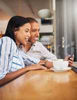 Happy couple reading social media on phone, bonding on a coffee break at a care. Smiling boyfriend and girlfriend browsing online, checking for discount and booking, enjoying free time off on weekend