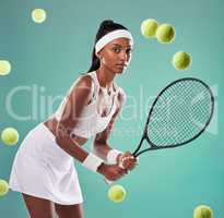 Tennis, sport and training with a young female player holding a racket and hitting balls in studio against a green background. Portrait of a healthy, fit and active athlete practicing for a game
