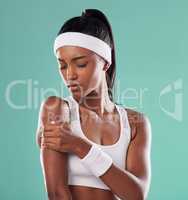 Tennis player with sports injury, hurt or pain in her arm after practice against green studio background. Professional female athlete suffering muscle strain, accident and inflammation on her body