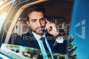 Calling the office to know whats happening. a handsome young corporate businessman on a call while commuting.