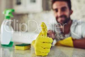 Housework is not just for women. a handsome young man cleaning his home.