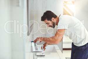 Hes big on oral hygiene. a handsome young man brushing his teeth in his bathroom at home.