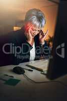 The body knows when its had enough. a mature businesswoman experiencing a headache during a late night at work.