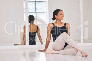 Ballet, ballerina and dancer sitting on floor during break and rest from dancing beautiful, elegant or classical choreography. Smiling professional performer in dance studio after practicing routine