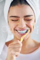 Youll see them sparkle when Im done. a beautiful young woman brushing her teeth in the bathroom at home.