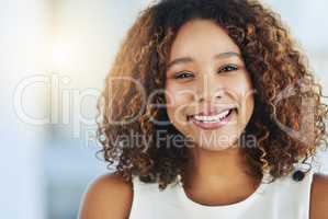 Success is dependent on your will and attitude. Portrait of a confident young businesswoman standing in an office.