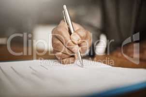 This is the first step. an unrecognizable businessperson signing papers inside of the office during the day.