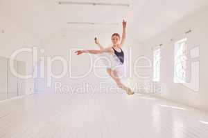 Ballet dancing and jumping practicing in a dance studio or class preparing for a performance. Young elegant dancer, performer or ballerina in the air performing and leaping high