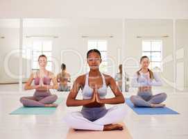 Meditating, yoga class or zen friends sitting together in relaxing, healthy or calm pilates studio. Diverse group of yogi women and namaste hand mudra in holistic breathing for mental health wellness