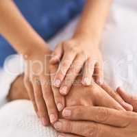 No stress ever required. Closeup of a unrecognisable persons hand being held by a doctor inside a medical clinic.