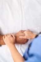 We will never let go. Closeup of a unrecognisable persons hand being held by a doctor inside a medical clinic.