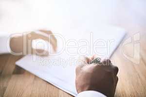 Sign if you accept our offer. a unrecognizable business person signing a document.