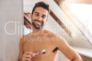 Start the day with fresh breath. Cropped portrait of a handsome young man brushing his teeth in his bathroom at home.