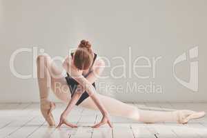Female ballet dancer in professional ballerina dance posture, dancing or difficult performance in studio rehearsal. Performing artist in point shoes and flexible legs, arms or art technique on floor